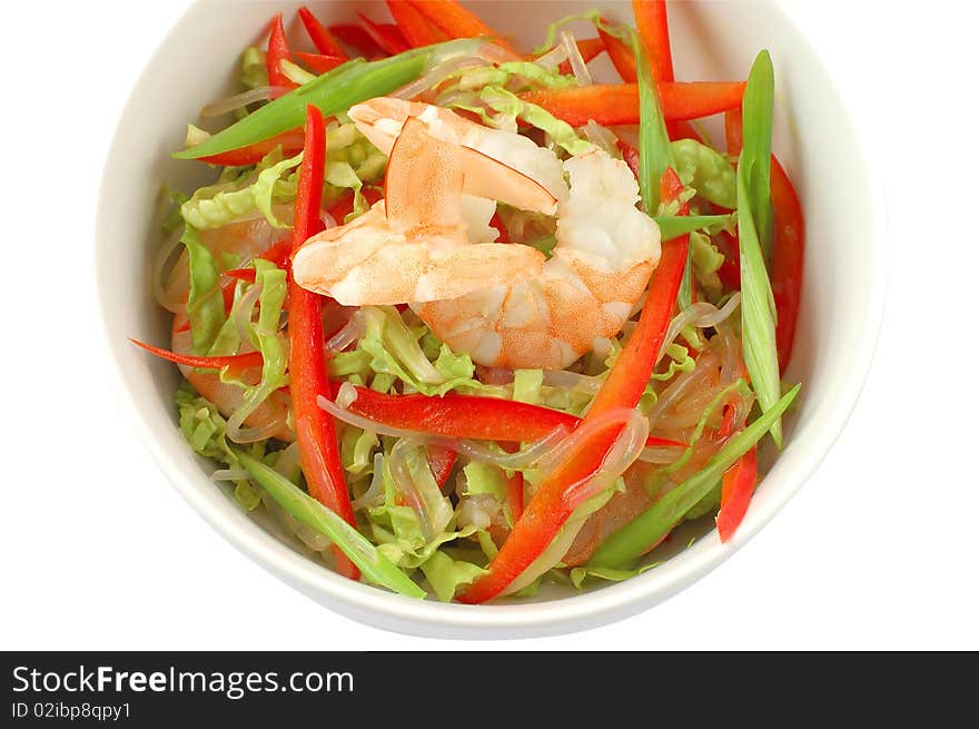 Salad with shrimps in a white plate on a white background