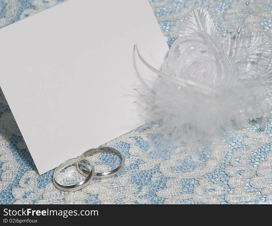 White card for congratulation on a background from blue  silk and white lace