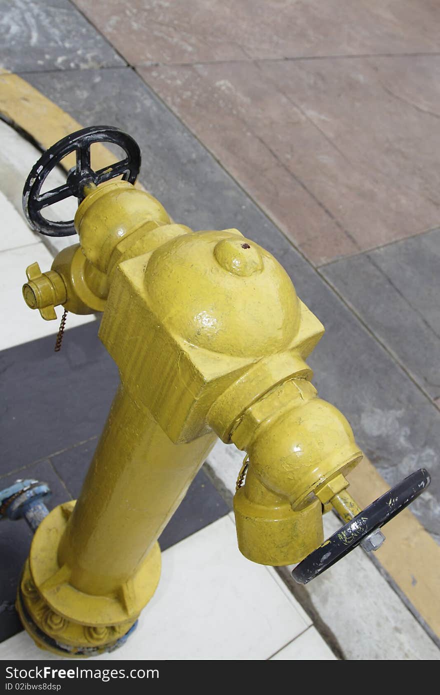 Yellow fire hydrant on a sidewalk