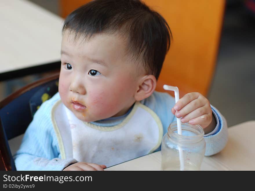 Asian little baby drink water at lunch time