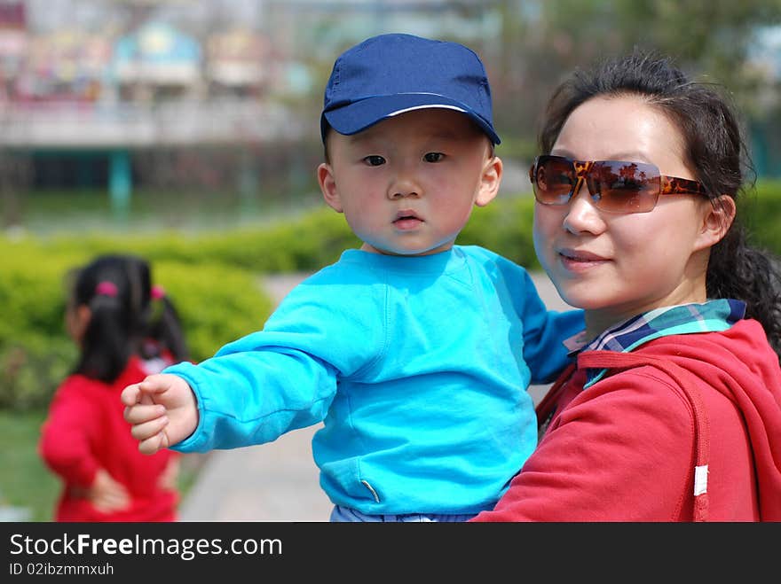 Cute baby boy with his mother in park. Cute baby boy with his mother in park