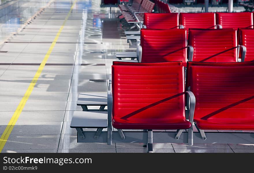 Lot of red seats in the empty airport