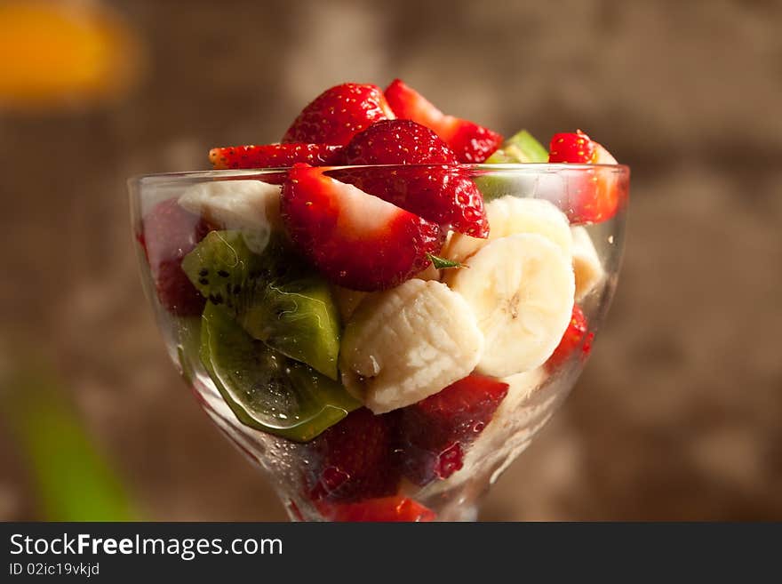 Photo of tasty fruitsalad in calix with strawberries. Photo of tasty fruitsalad in calix with strawberries