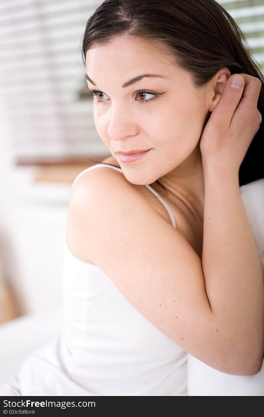 Young attractive brunette woman lying in bed. Young attractive brunette woman lying in bed