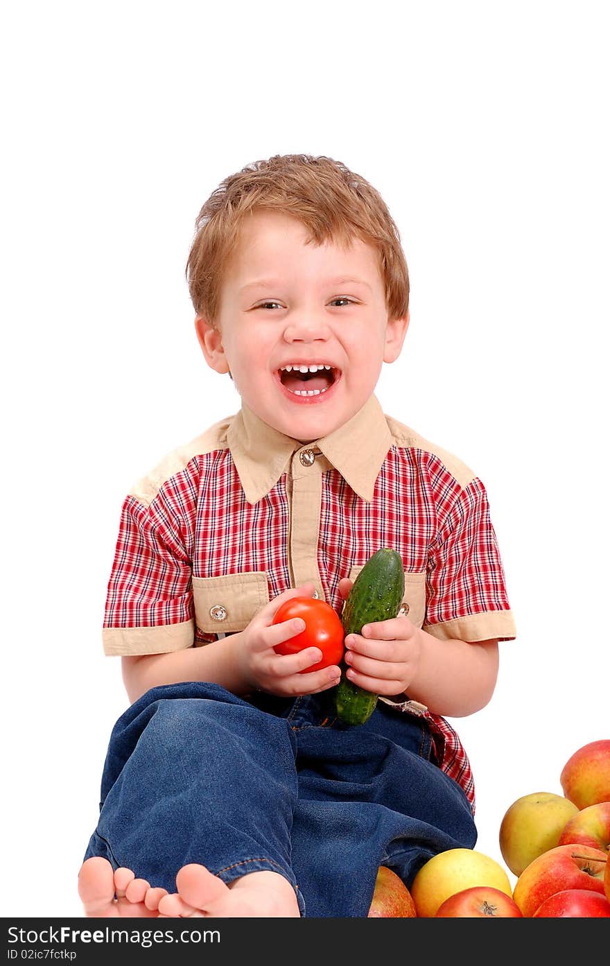 The little boy with fruit and vegetables isolated on white background