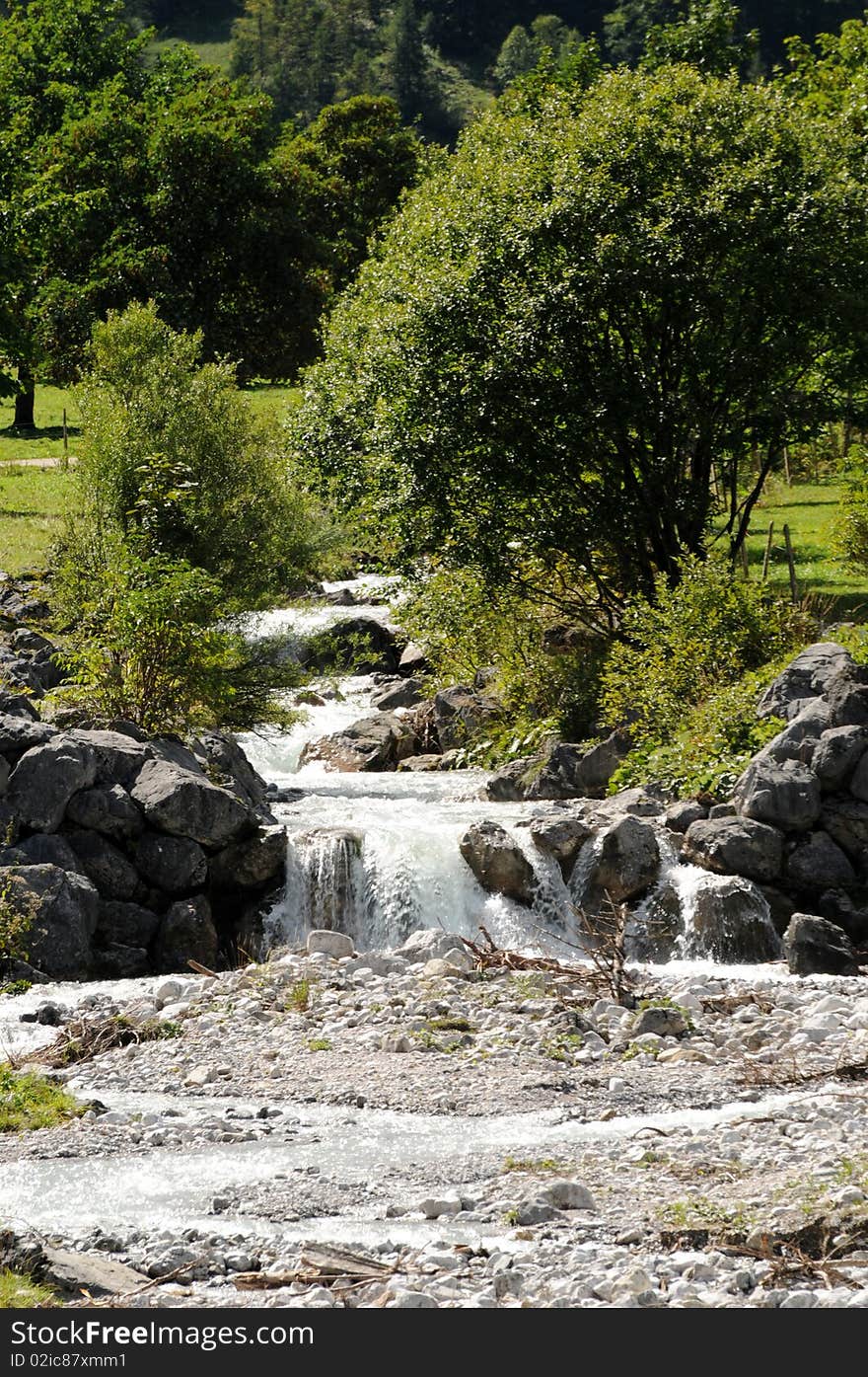 A small waterfall in the mountains. A small waterfall in the mountains.