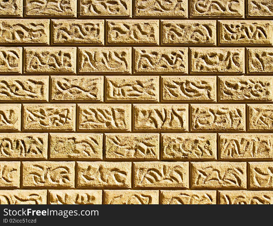 Yellow decorative brick wall closeup. Yellow decorative brick wall closeup.