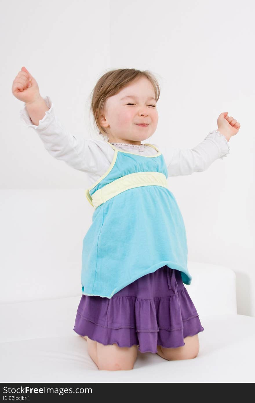 Happy little girl on sofa