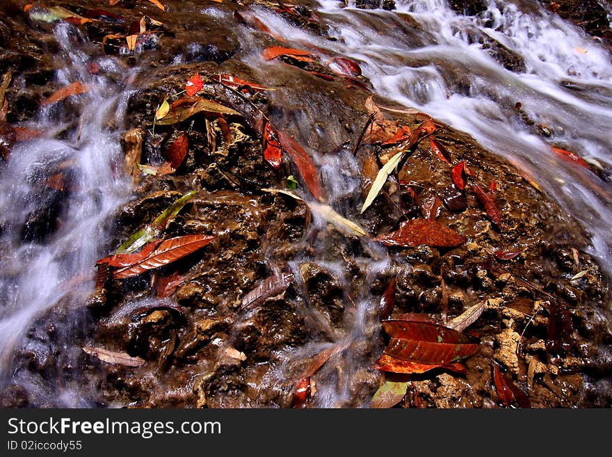 Waterfall with dry stones in warm colors