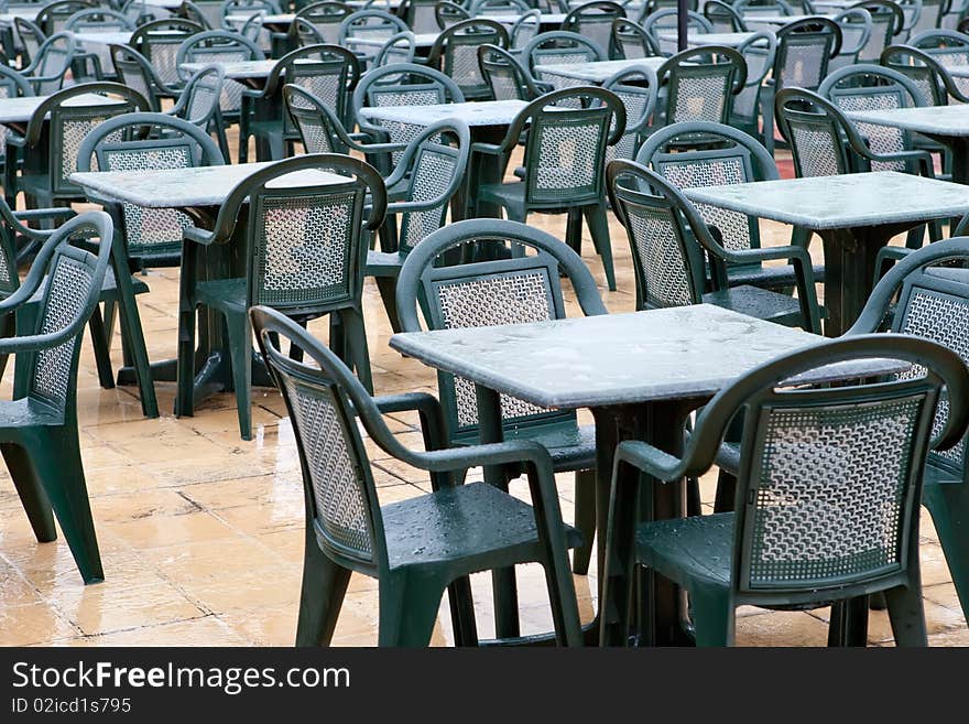 Many Green plastic chairs and tables