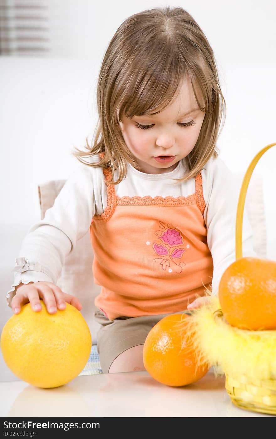 Happy little girl with fruits