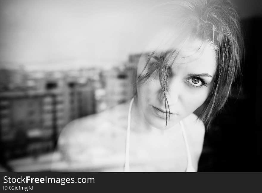 Portrait of a young lady behind a window. Portrait of a young lady behind a window