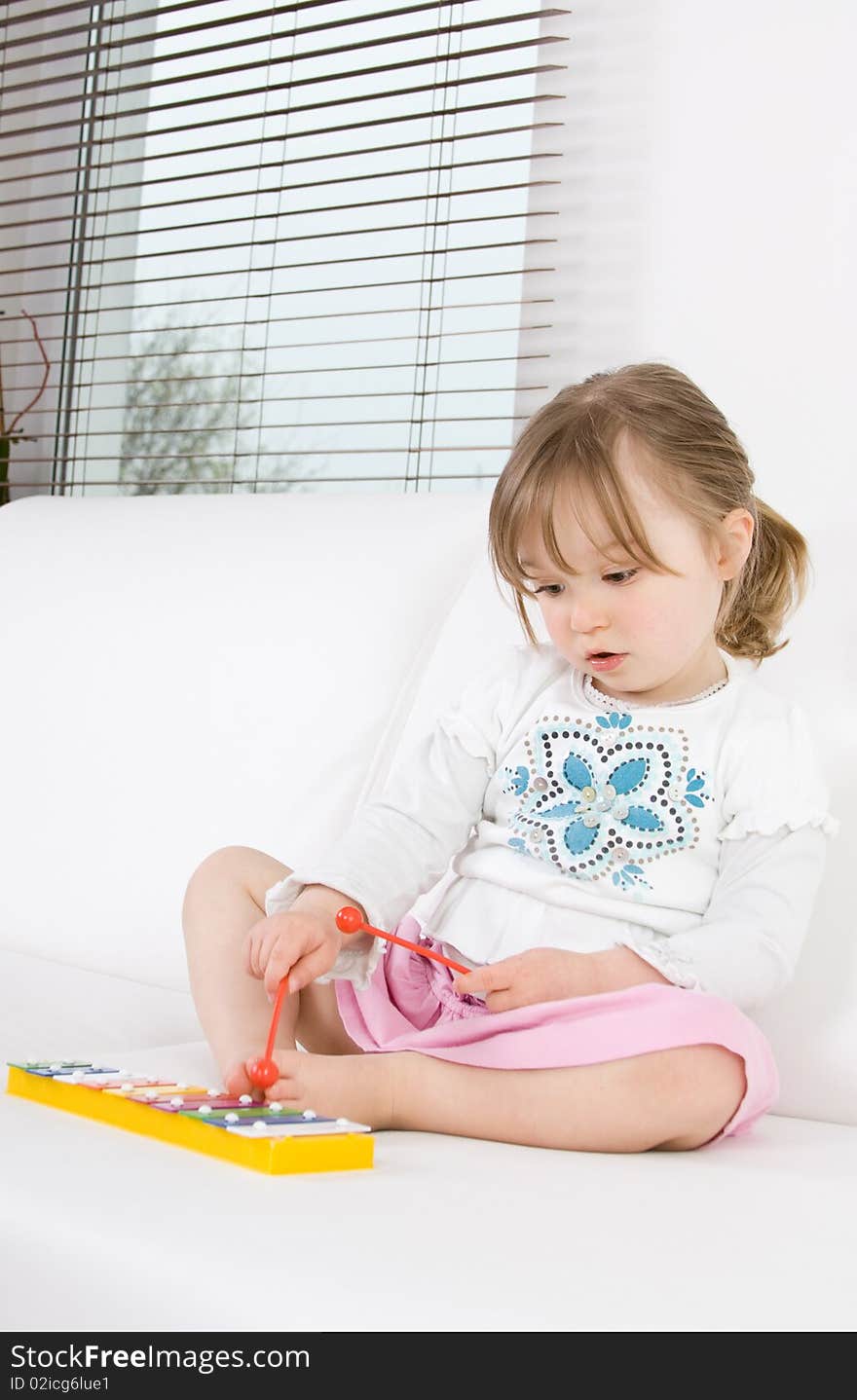 Sweet toddler little girl with instrument