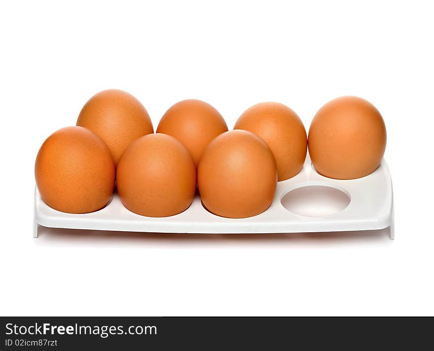 Chicken brown eggs in container isolated on white