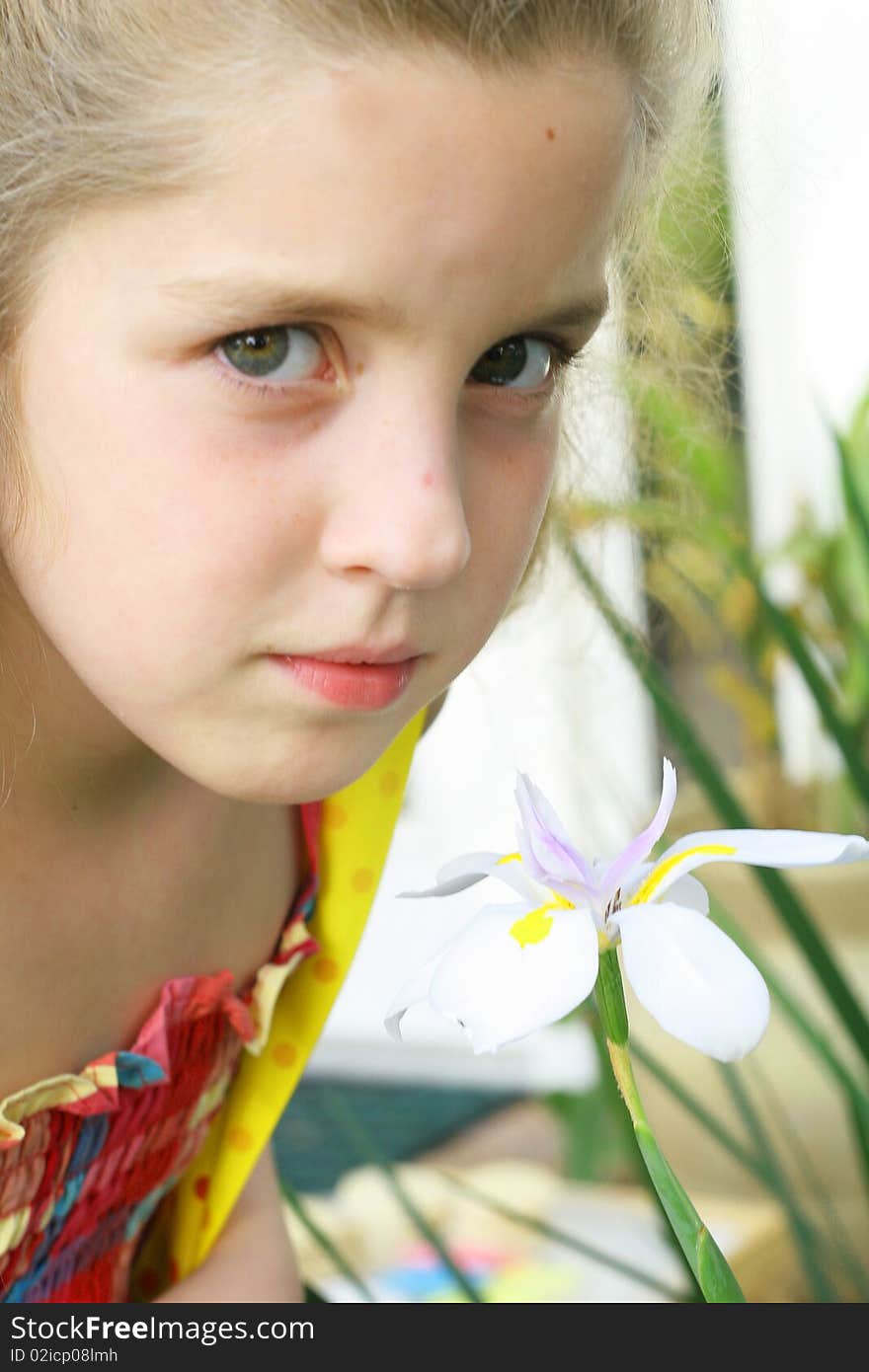 Shot of a beautiful little girl by flower