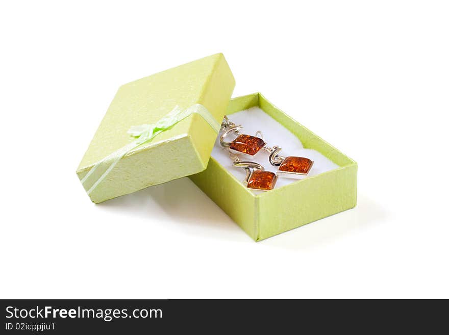 Green gift box with ribbon with jewelry