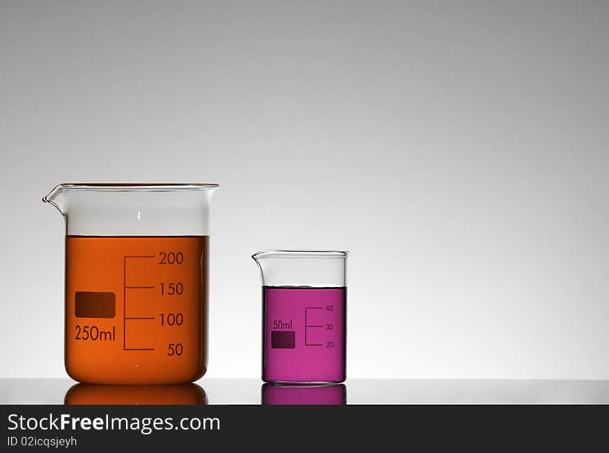 Two beakers with red and pink liquid