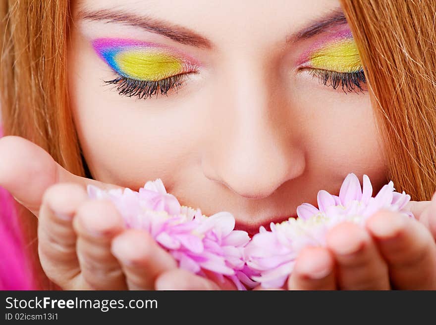 Young pretty girl smelling flower