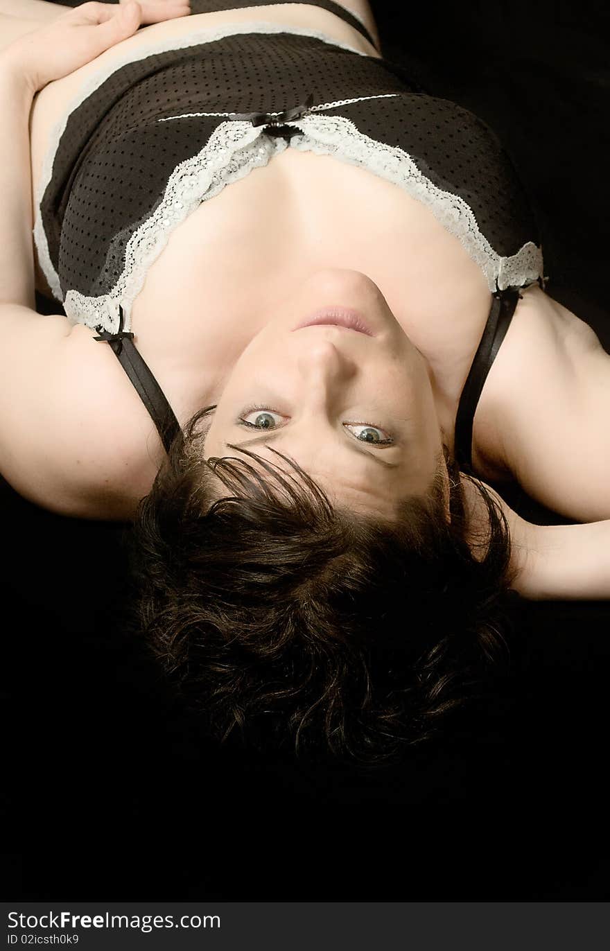 woman wearing lingerie over a black background. woman wearing lingerie over a black background.