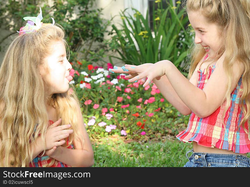 Shot of teasing sisters with sticky fingers