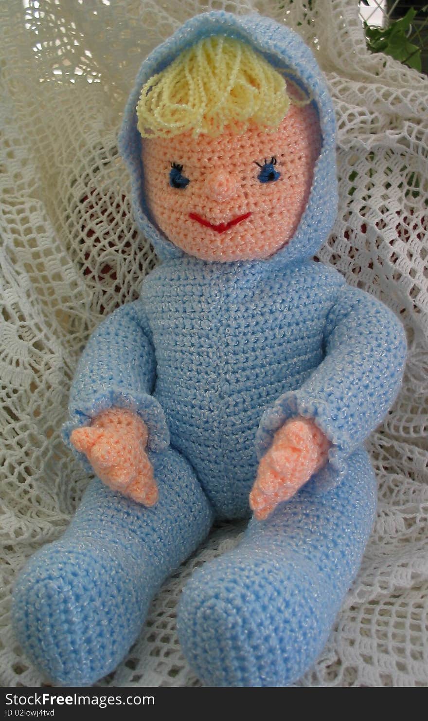 Crocheted Doll Wearing Blue