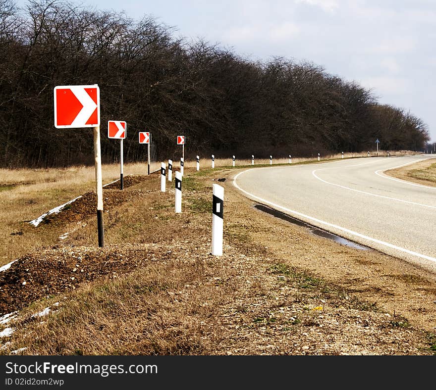 The asphalted turn of road with turn indexes. The asphalted turn of road with turn indexes