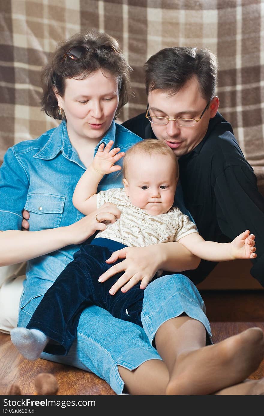 Happy family. Father and mother embrace the small son.