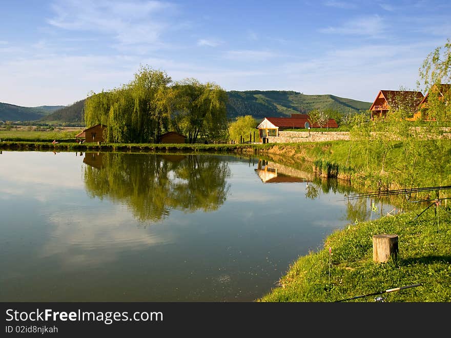 View of the houses near a lake in Viforoasa, Mures, Romania. View of the houses near a lake in Viforoasa, Mures, Romania