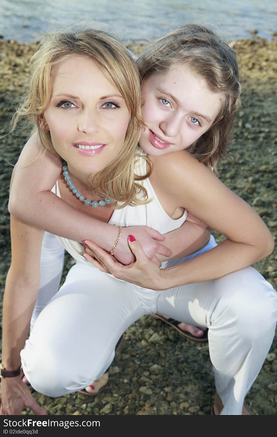 Mother and daughter lifestyle image on the shoreline of Miami's Biscayne Bay.