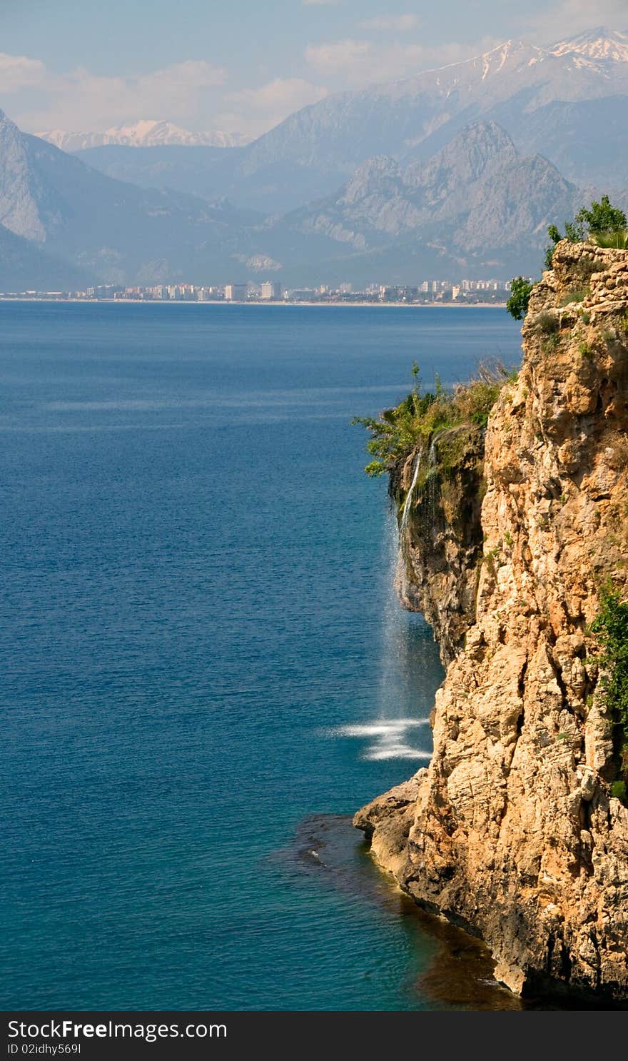 Waterfall at the cliffs on the mediterranean sea