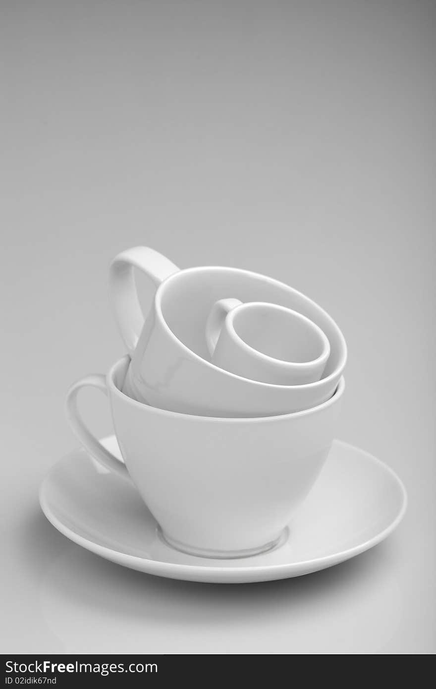 Tea and coffee cups on white tablecloth