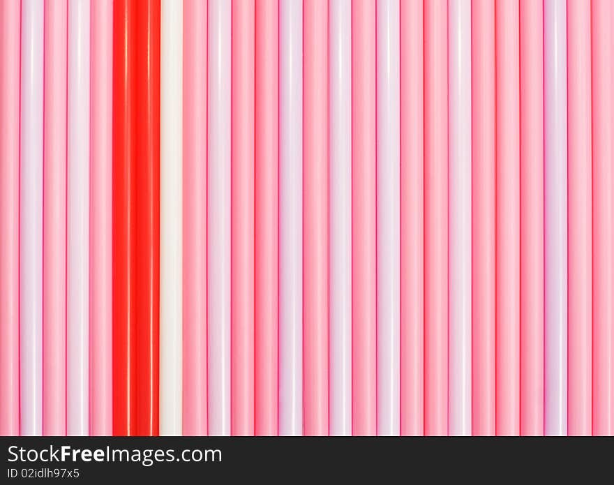 Striped background of pink drinking straws