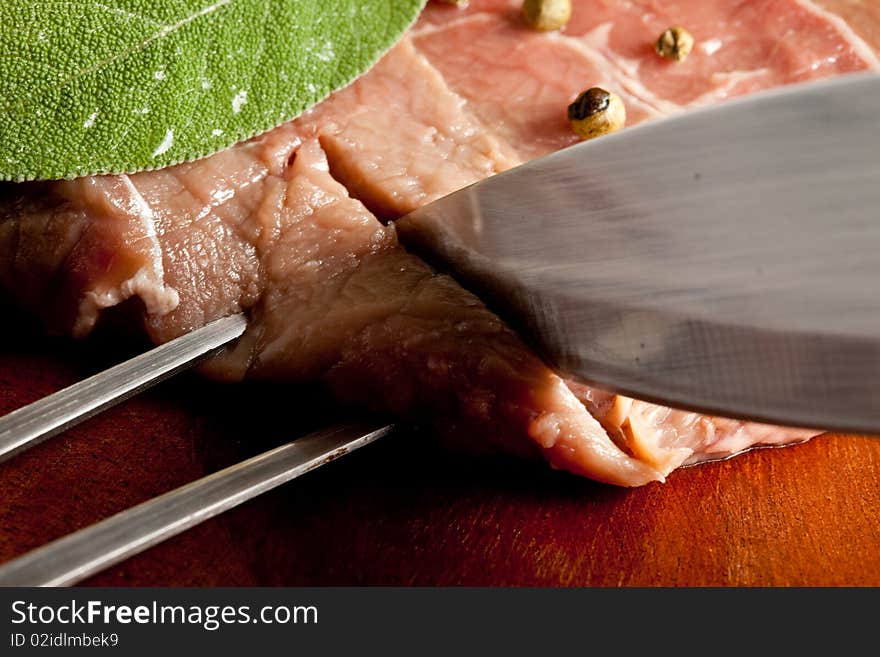 Photo of steak on a chopping board which is going to be cutted