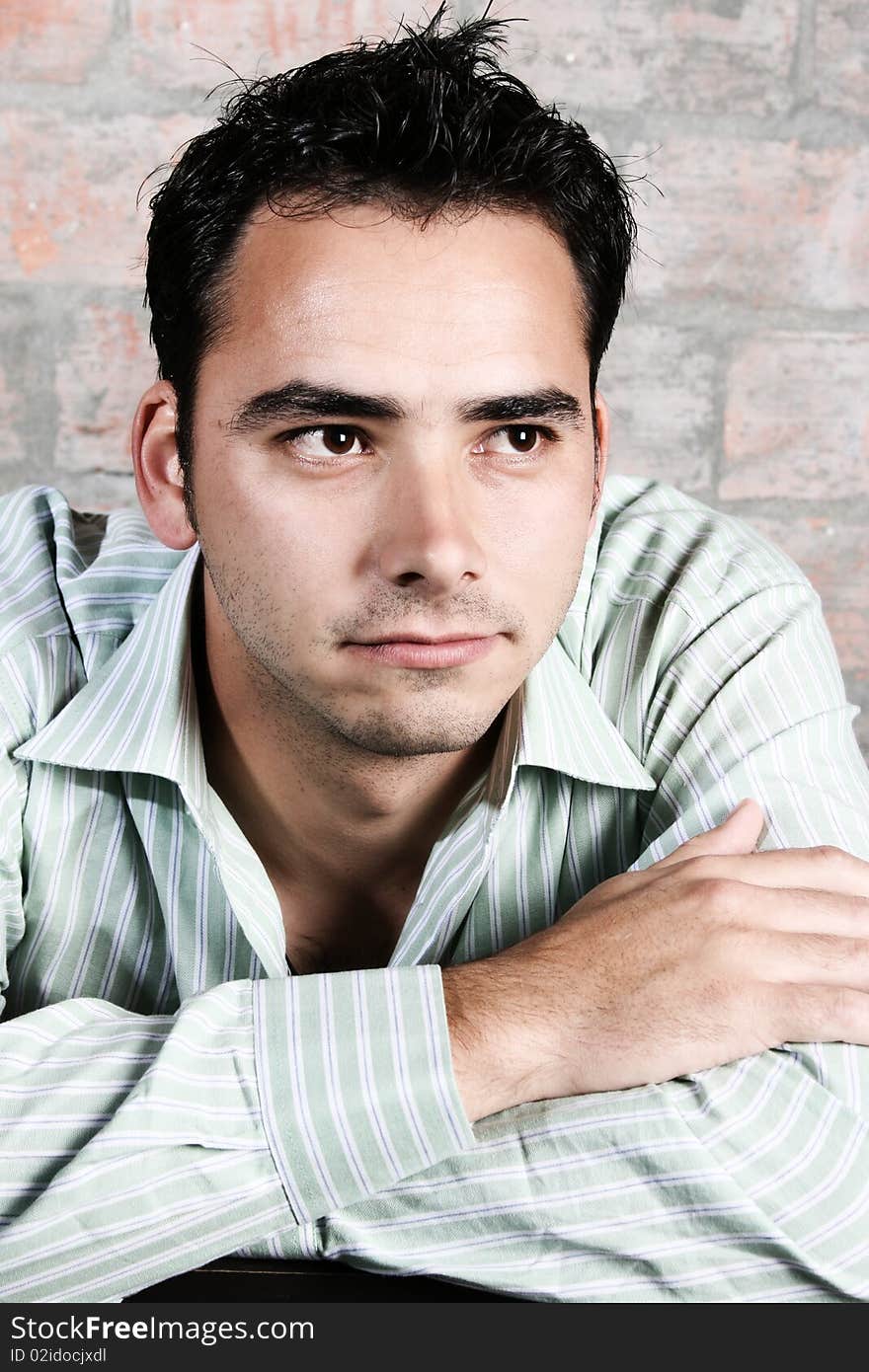 Male model against a rough brick wall background. Male model against a rough brick wall background