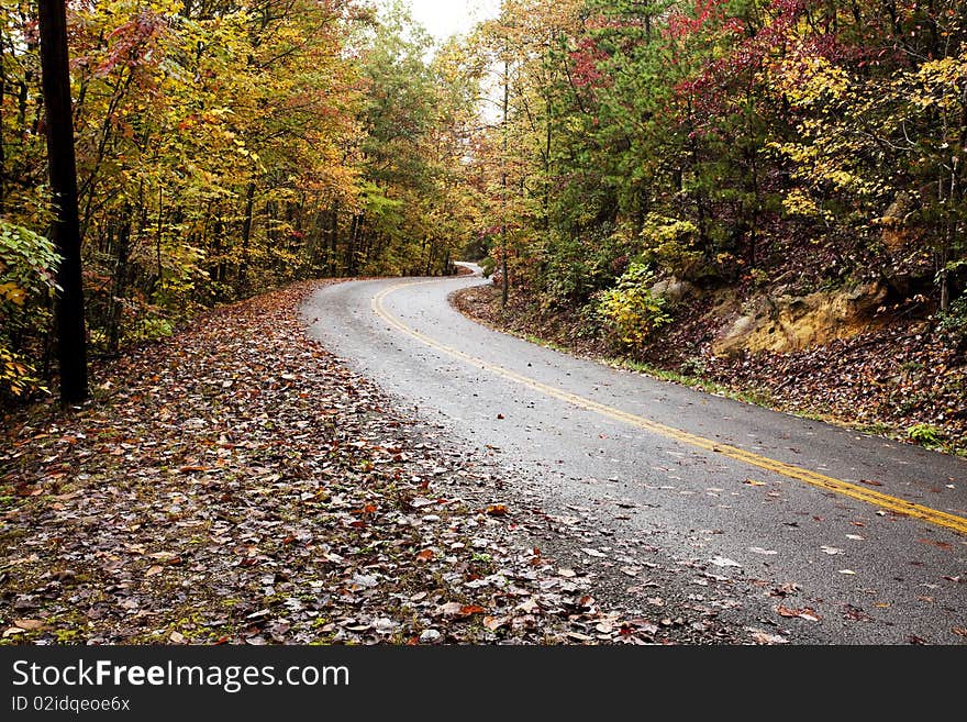 Winding road through colorful mountains in fall. Winding road through colorful mountains in fall