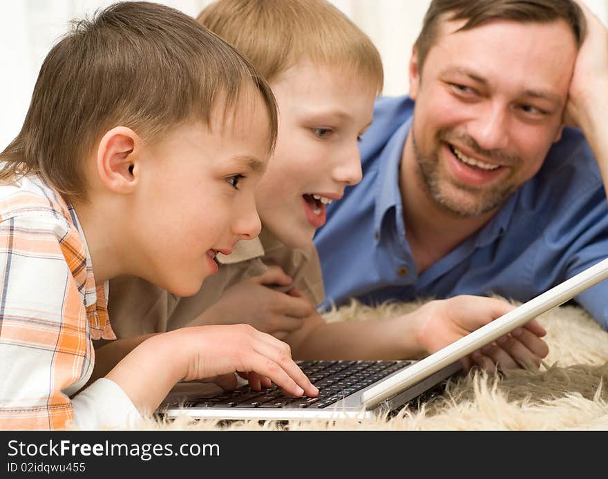 Two brothers playing on a laptop