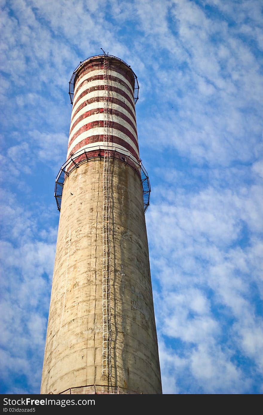 Industry chimney in a blue sky on sunny day