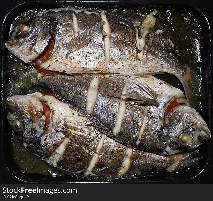 Three small dorada baked in an oven