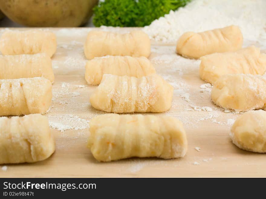 Homemade Italian Gnocchi pasta on wooden board.