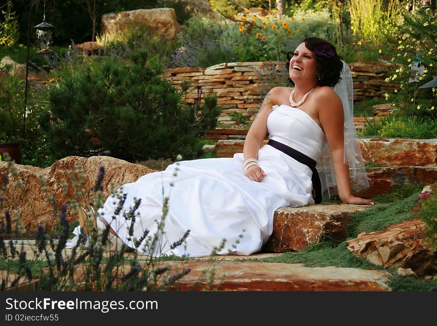 Horizontal image of bride laughing at her maid of honor pulling faces off camera. Horizontal image of bride laughing at her maid of honor pulling faces off camera.