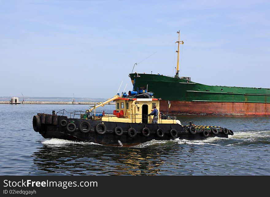 Tow and cargo ship arriving to sea port. Tow and cargo ship arriving to sea port