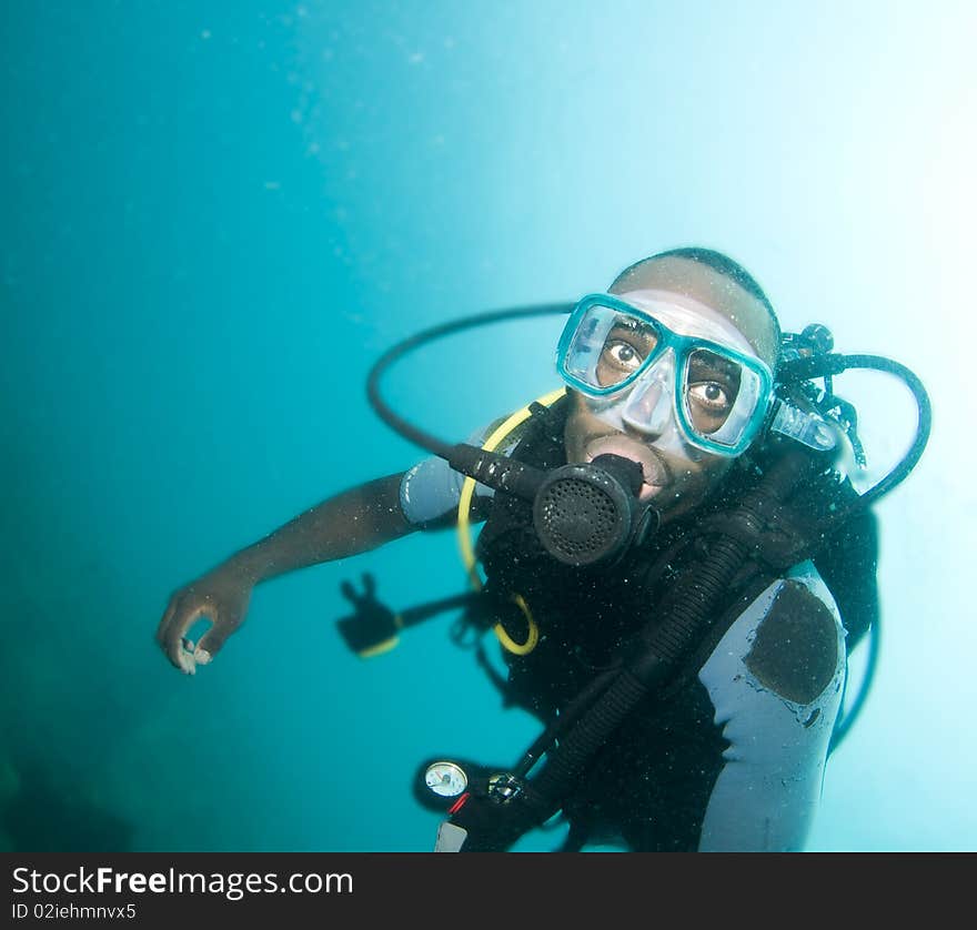 Scuba diver portraite in blue water