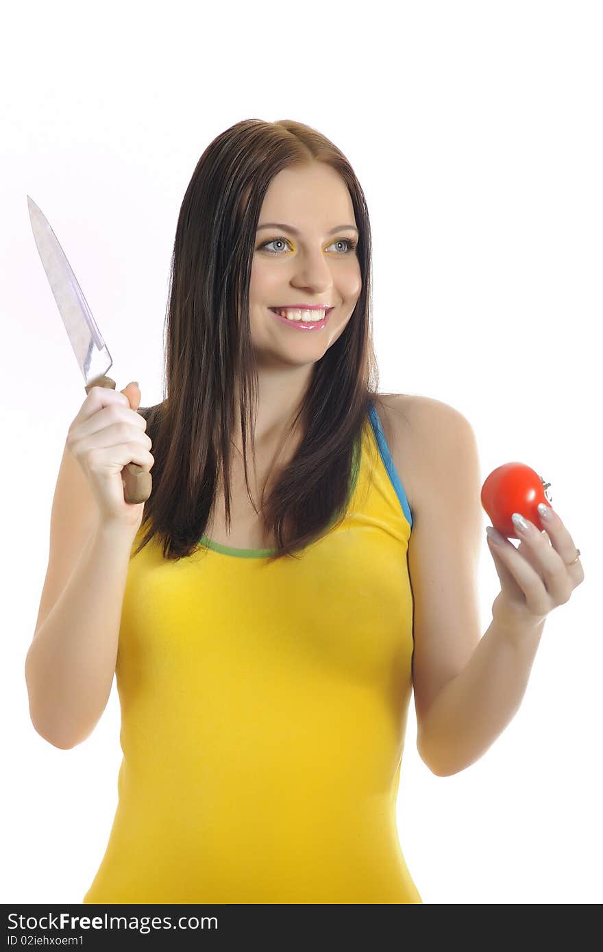 Young pretty woman with red tomato and a knife. white background