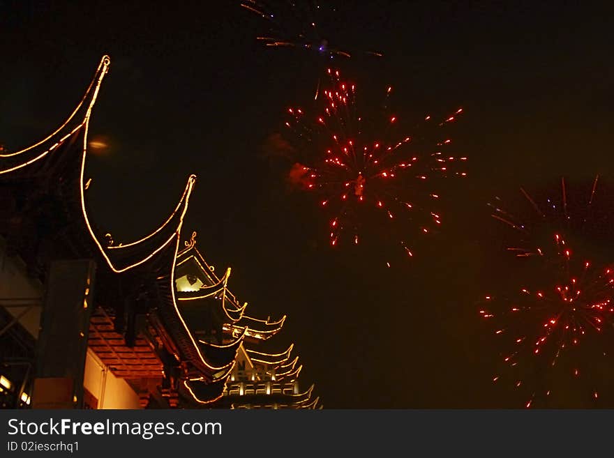 Chinese ancient building decorated in lighting，with fireworks，took at Shanghai,China. Chinese ancient building decorated in lighting，with fireworks，took at Shanghai,China.