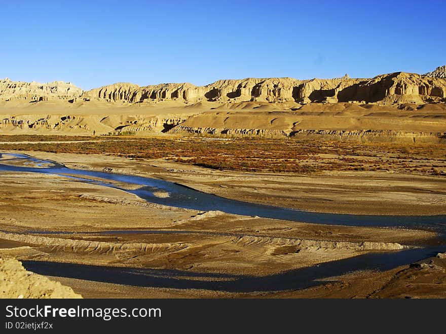 River cut through ground,with clay mountain background. shoot at tibet,China.