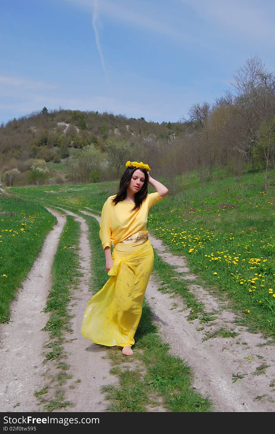 The beautiful girl walks on a solar meadow