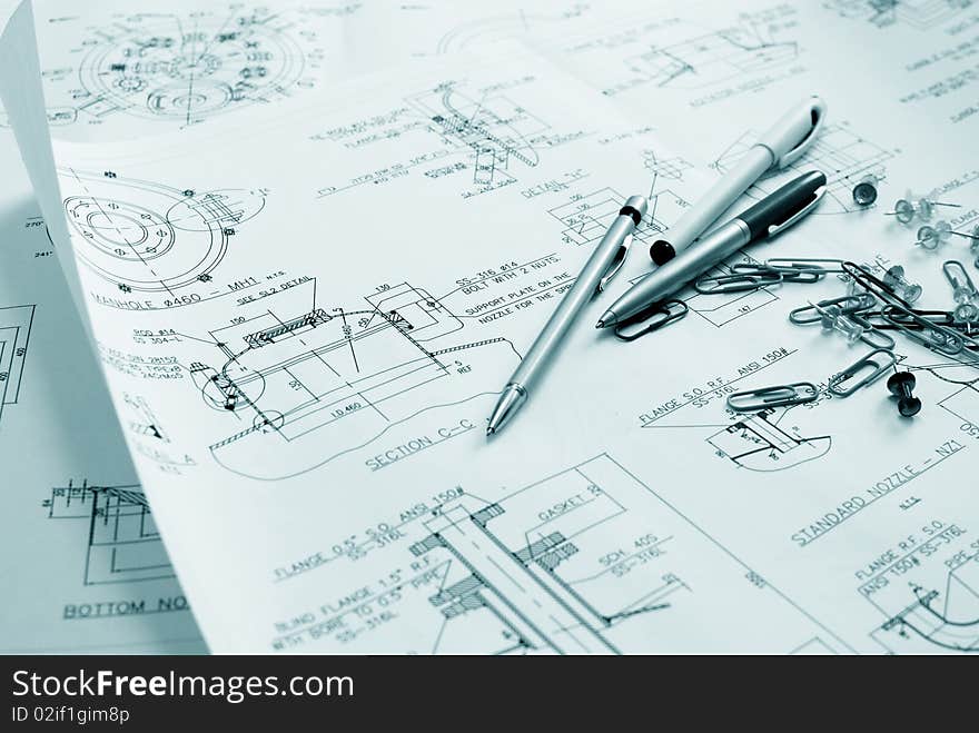 An engineer's technical drawings and other office material close-up