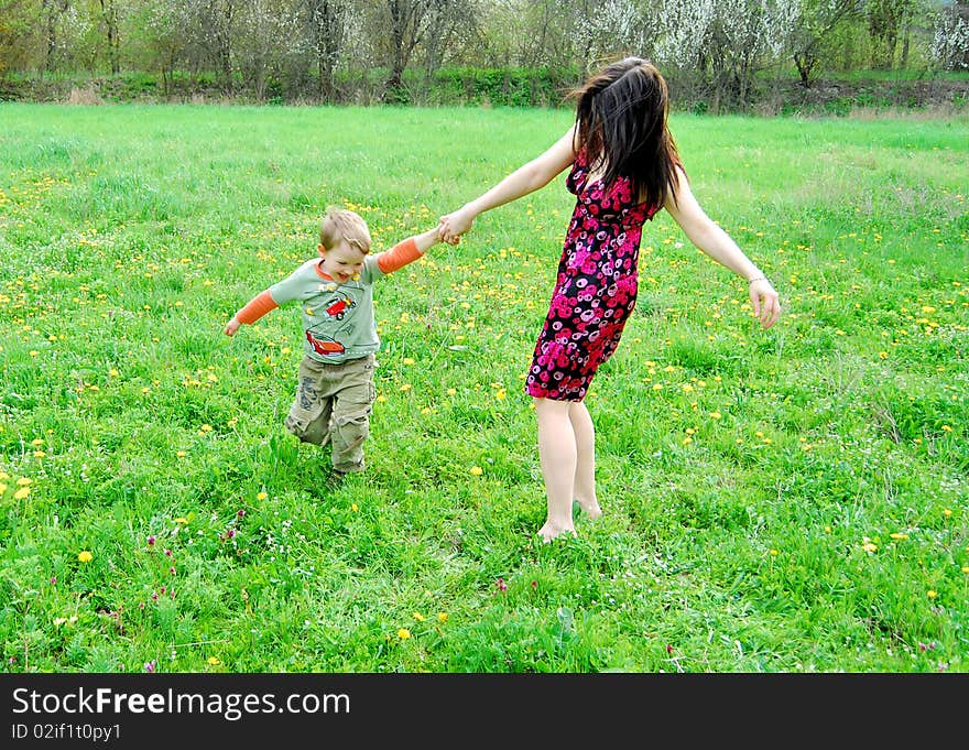 Mum and the son on a walk in the meadow