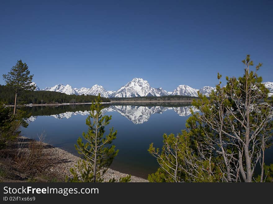 Reflection in the lac of the Grand Tetons in Wyoming surrounded by nature