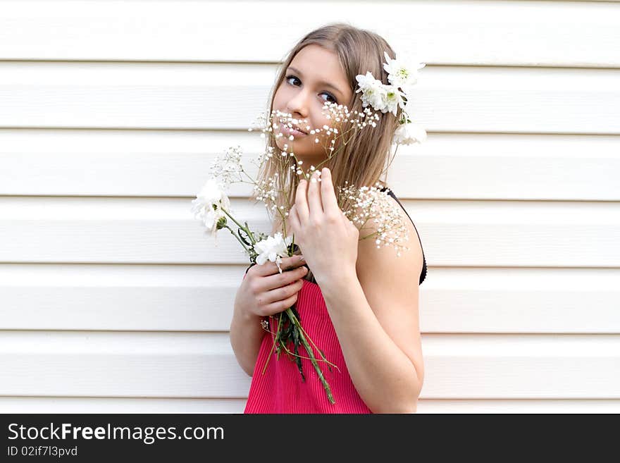 Girl with flowers posing outdoor